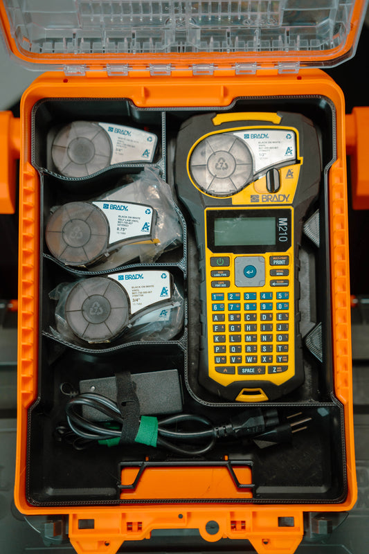 M210 Label printer and supplies in an orange carrying case
